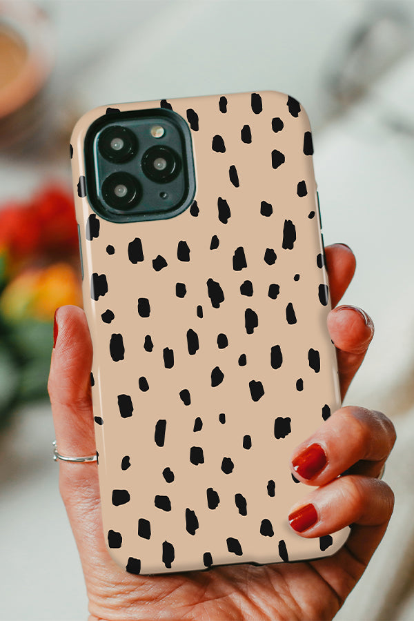 Beige phone case with black hand-drawn polka dots