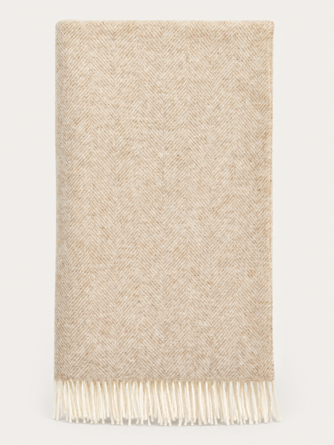 A folded beige woven scarf with a subtle herringbone pattern and fringed edges, shown against a plain white background.