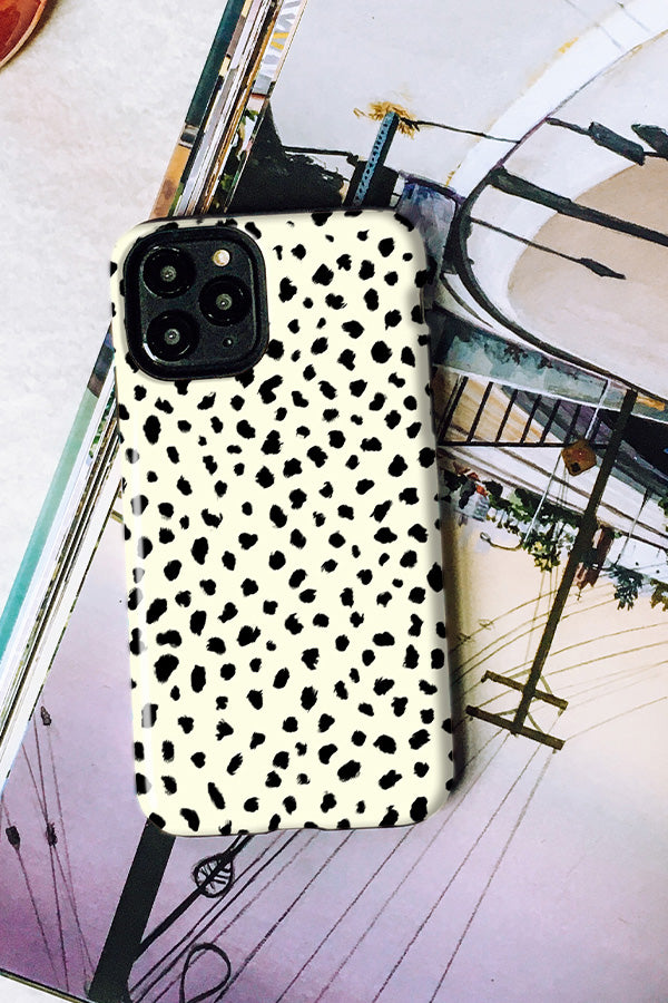 Phone case with black and white dalmatian pattern on a magazine background