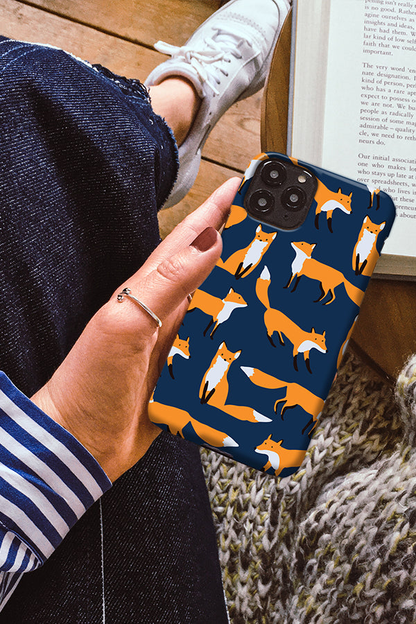 Person holding a phone with an illustrated fox phone case