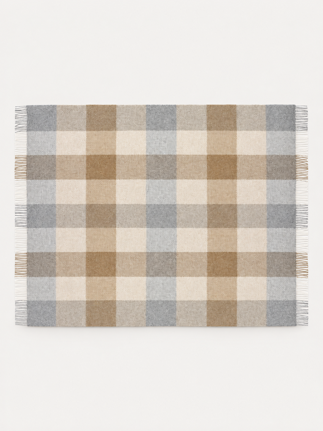 A rectangular woven throw blanket with a classic plaid check pattern in beige, brown, light gray, and off-white, featuring fringed edges on all sides, shown flat against a plain white background.