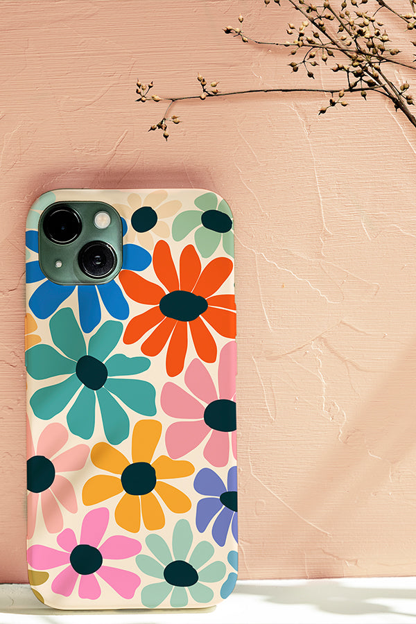 Phone case with an abstract colourful floral pattern resting against a cream background