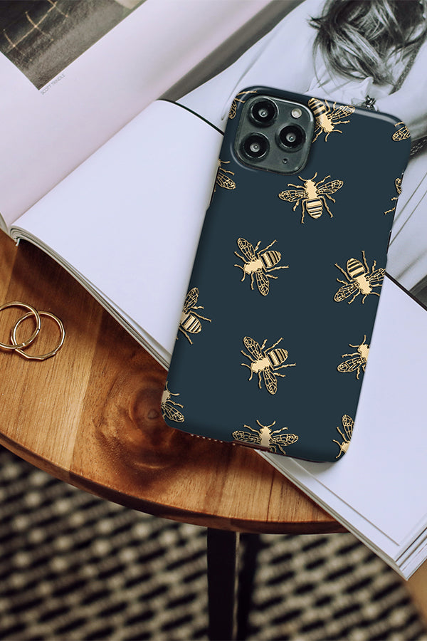 Phone case with bee pattern on a wooden table
