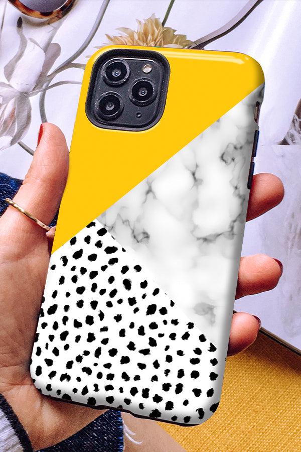 Phone case with a yellow colour block, marble print and a dalmatian animal print on the bottom