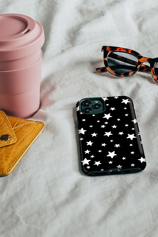 Phone case with a black background with white hand-drawn stars 