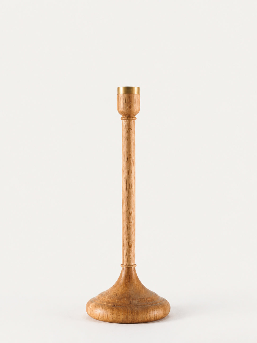 A single wooden candlestick with a flared base and a cylindrical stem, shown on a plain light background.