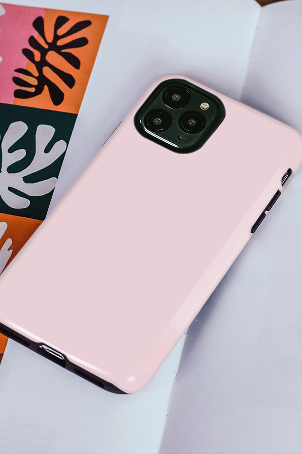 Pink phone case on a light grey surface 