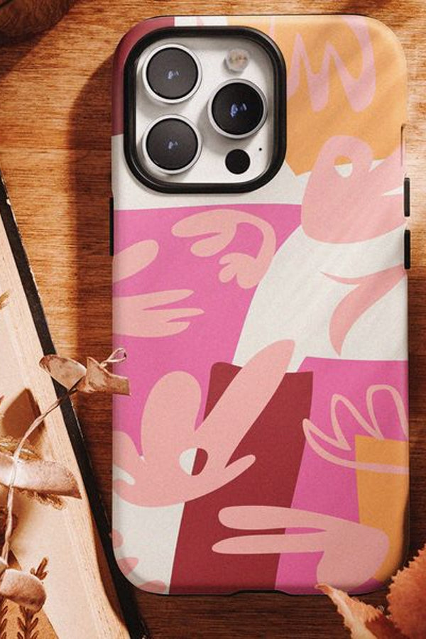 Phone case with abstract pink and beige design on a wooden surface