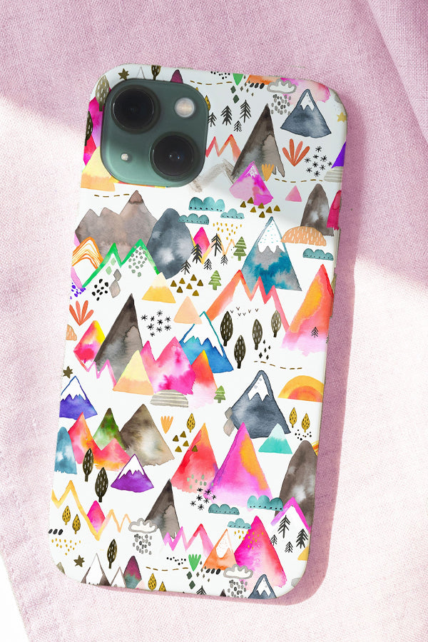 Phone case with colorful mountain design on a pink fabric background