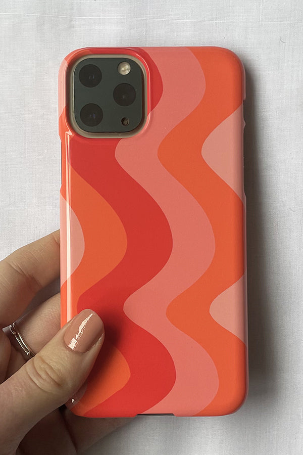 Phone case with a pink and red wavy pattern 