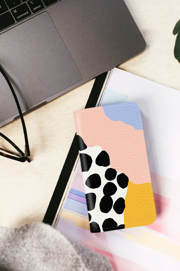 Wallet phone case with a pastel colour palette with polka dots and wavy colour blocks